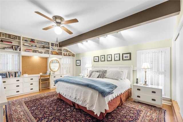 bedroom with vaulted ceiling with beams, a ceiling fan, and wood finished floors