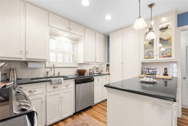 kitchen with pendant lighting, light wood-style flooring, white cabinets, a sink, and dishwasher