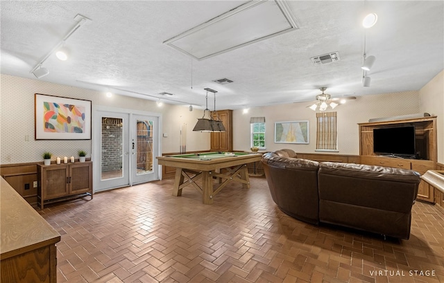 5222 Wooldridge, Corpus Christi, TX 78413 - game room featuring track lighting, attic access, a textured ceiling, wallpapered walls, and french doors