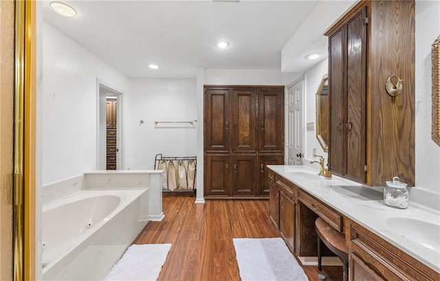 5222 Wooldridge, Corpus Christi, TX 78413 - bathroom featuring a garden tub, double vanity, wood finished floors, and recessed lighting