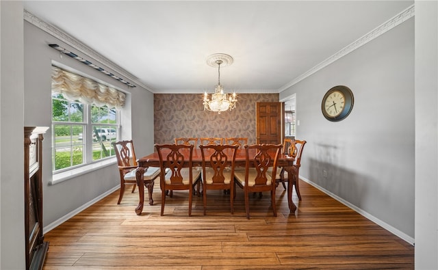 5222 Wooldridge, Corpus Christi, TX 78413 - dining space featuring an accent wall, a chandelier, light wood-type flooring, wallpapered walls, and crown molding
