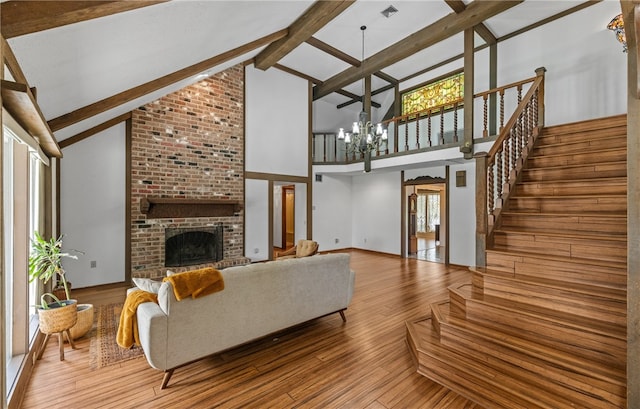 5222 Wooldridge, Corpus Christi, TX 78413 - living room with a chandelier, a brick fireplace, high vaulted ceiling, beam ceiling, and wood finished floors