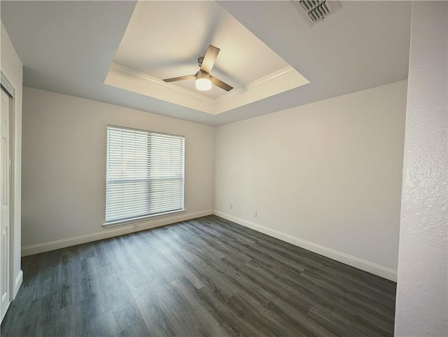 4010 Moorhead Dr, Corpus Christi, TX 78410 - empty room featuring a raised ceiling, ornamental molding, ceiling fan, and dark wood-style floors