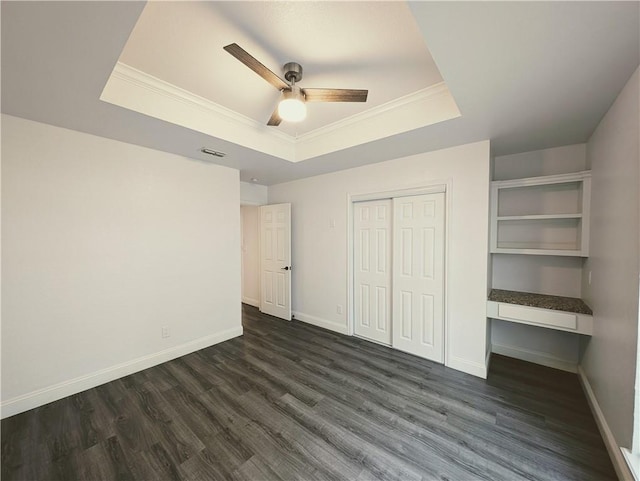 4010 Moorhead Dr, Corpus Christi, TX 78410 - unfurnished bedroom featuring a tray ceiling, ornamental molding, dark wood-style flooring, a closet, and a ceiling fan