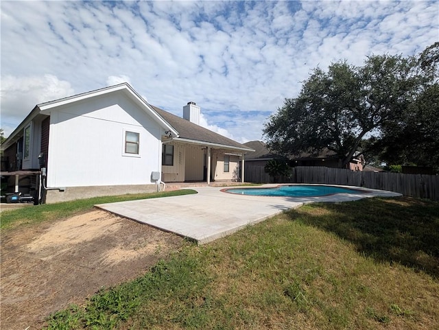4010 Moorhead Dr, Corpus Christi, TX 78410 - rear view of house with a fenced backyard, a chimney, and a patio