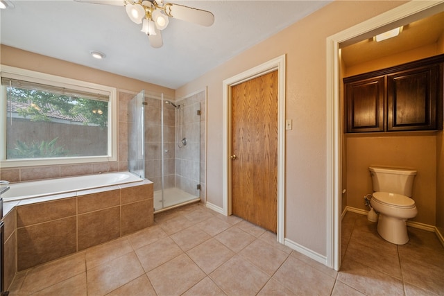 bathroom with independent shower and bath, ceiling fan, tile patterned flooring, and toilet