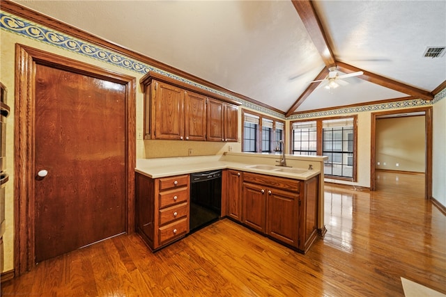 kitchen featuring dishwasher, kitchen peninsula, vaulted ceiling with beams, and hardwood / wood-style flooring