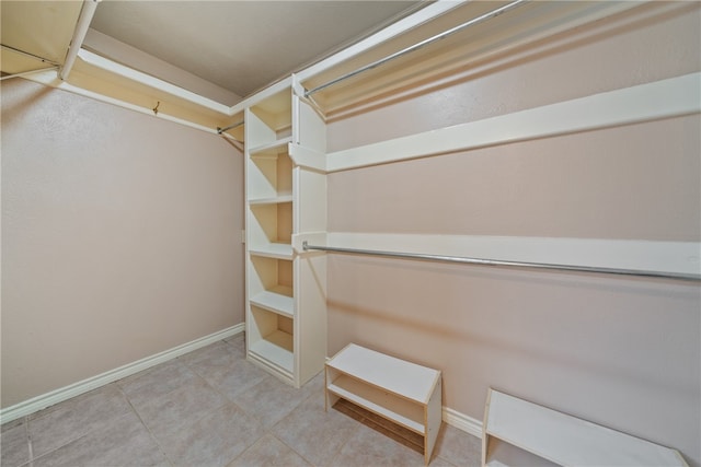 spacious closet featuring light tile patterned floors