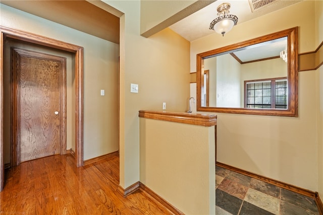 corridor with hardwood / wood-style floors