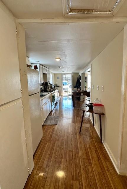 hallway with dark hardwood / wood-style floors