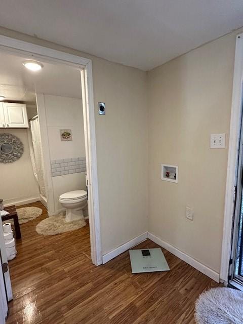 laundry room featuring dark hardwood / wood-style flooring and hookup for a washing machine