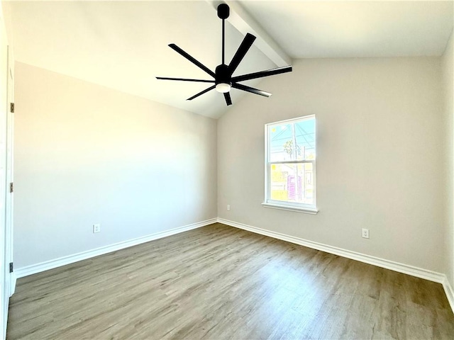 unfurnished room with vaulted ceiling with beams, ceiling fan, wood finished floors, and baseboards