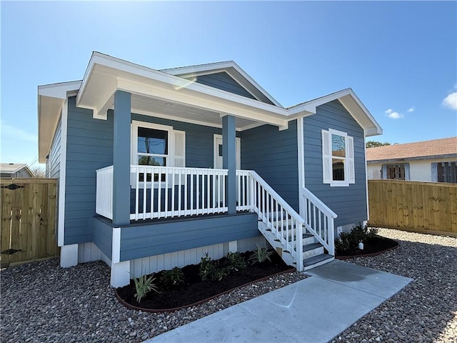 view of front facade with a porch and fence