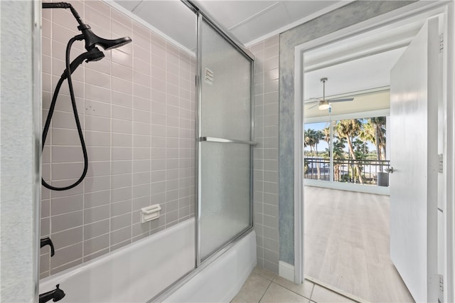 bathroom with bath / shower combo with glass door, hardwood / wood-style floors, and ceiling fan