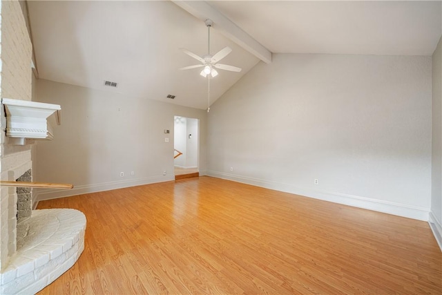 unfurnished living room featuring visible vents, a ceiling fan, vaulted ceiling with beams, a fireplace, and light wood-style flooring