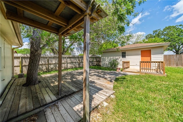 wooden deck featuring a lawn and a fenced backyard