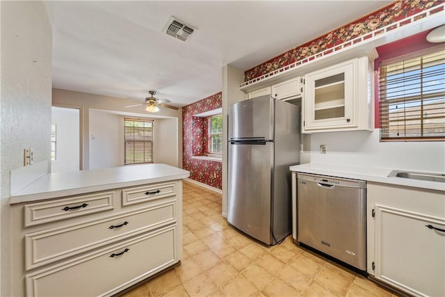 kitchen with light floors, stainless steel appliances, light countertops, and visible vents