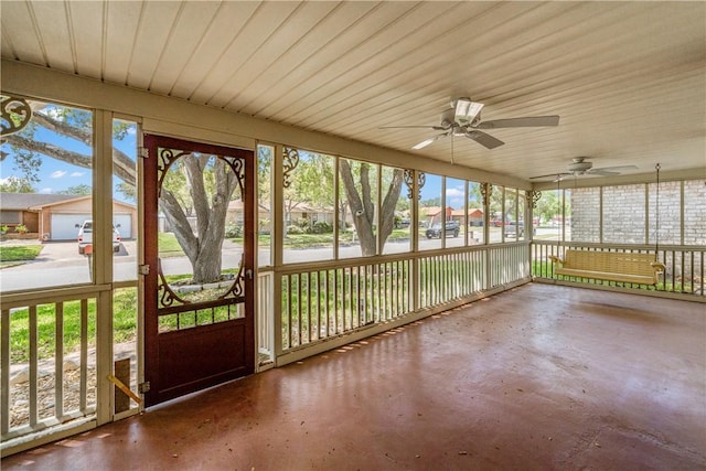 unfurnished sunroom with a ceiling fan