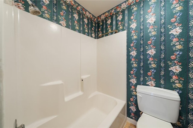 full bath with toilet and baseboards