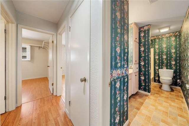 corridor featuring baseboards