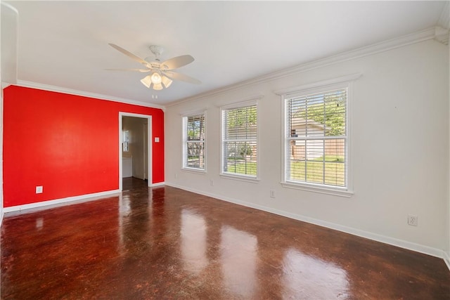 spare room featuring ornamental molding, baseboards, concrete flooring, and ceiling fan