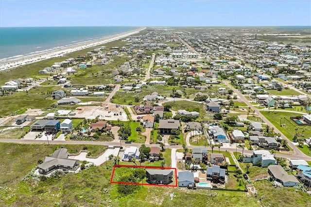 aerial view featuring a water view, a view of the beach, and a residential view
