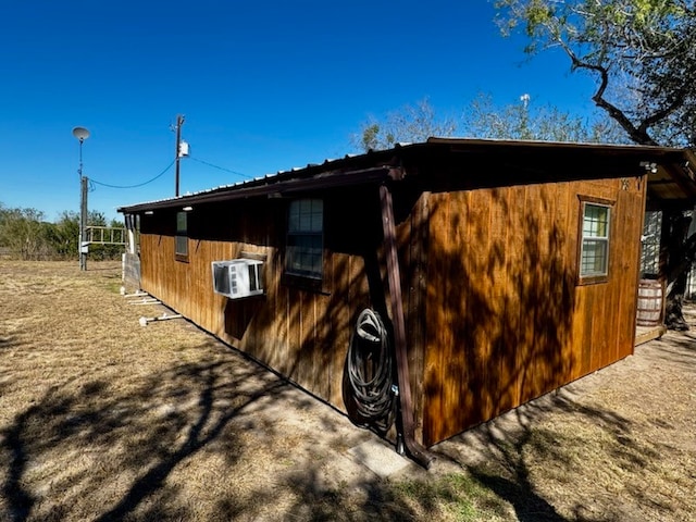 exterior space featuring a wall unit AC