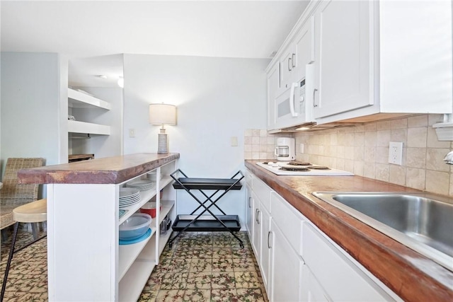 kitchen featuring white cabinets, open shelves, white appliances, a breakfast bar area, and decorative backsplash