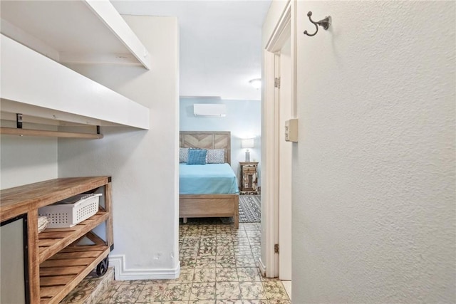 hall featuring baseboards and a textured wall
