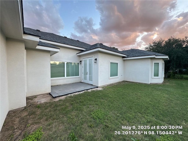 113 Gonzalez Dr, San Juan, TX 78589 - back of property with stucco siding, a yard, a shingled roof, and a patio