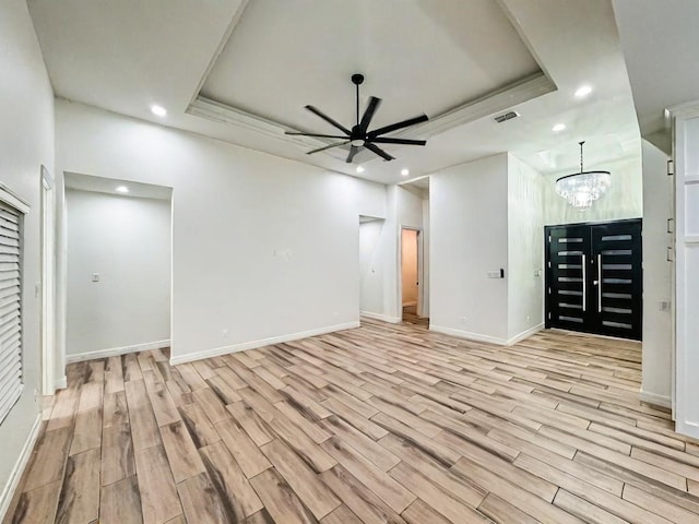 113 Gonzalez Dr, San Juan, TX 78589 - unfurnished room with a tray ceiling, recessed lighting, light wood finished floors, a chandelier, and a ceiling fan