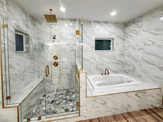 113 Gonzalez Dr, San Juan, TX 78589 - full bath with a tub with jets, a marble finish shower, wood finished floors, tile walls, and recessed lighting
