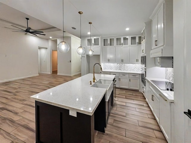 113 Gonzalez Dr, San Juan, TX 78589 - kitchen with oven, light wood-style flooring, ceiling fan, black electric stovetop, and recessed lighting