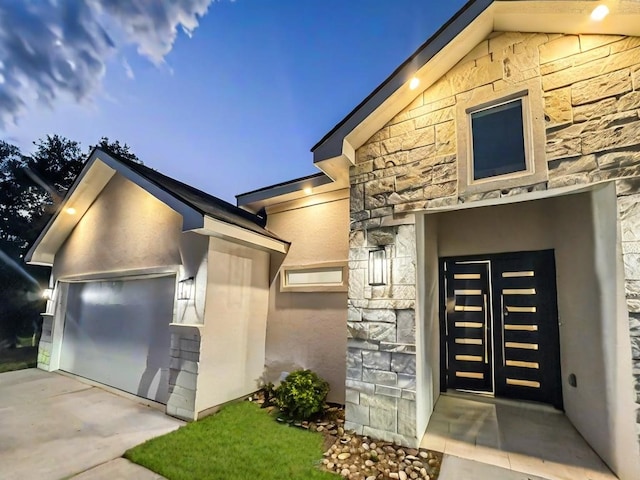 113 Gonzalez Dr, San Juan, TX 78589 - view of front facade with stone siding and a garage