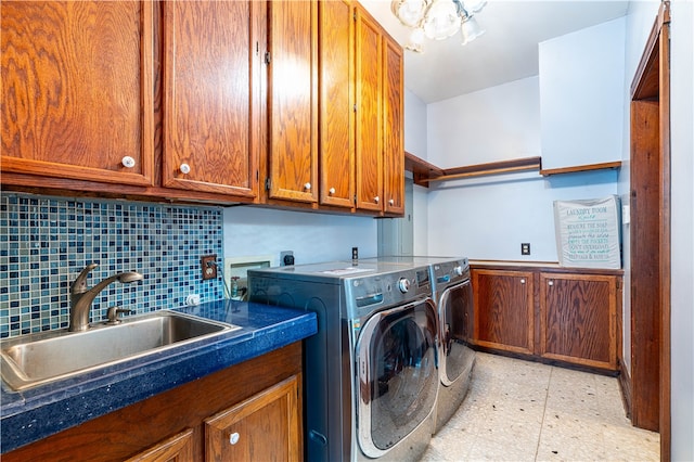 laundry area with cabinets, sink, and washing machine and clothes dryer