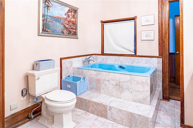 bathroom with toilet and a relaxing tiled tub