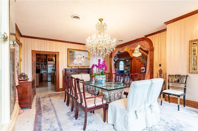 121 Glenmore St, Corpus Christi, TX 78412 - dining room with ornamental molding, a chandelier, stairs, and inlaid floor details
