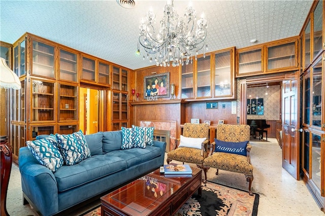 121 Glenmore St, Corpus Christi, TX 78412 - living room featuring a chandelier, built in shelves, and wood walls