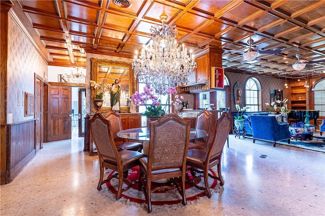 dining area with ceiling fan with notable chandelier and coffered ceiling