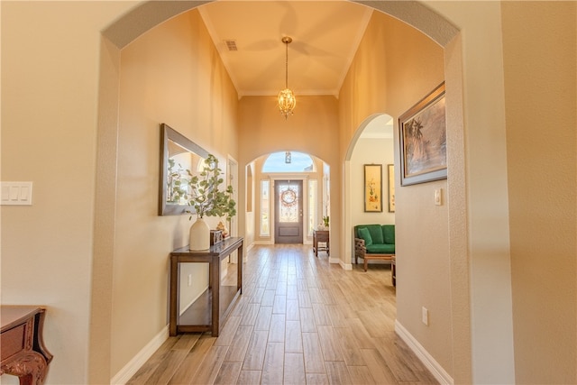 entrance foyer with light wood-type flooring and crown molding