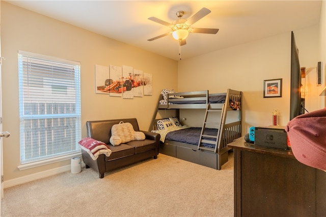 carpeted bedroom with multiple windows and ceiling fan