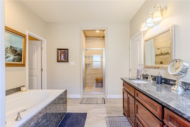 bathroom featuring hardwood / wood-style flooring, vanity, and independent shower and bath