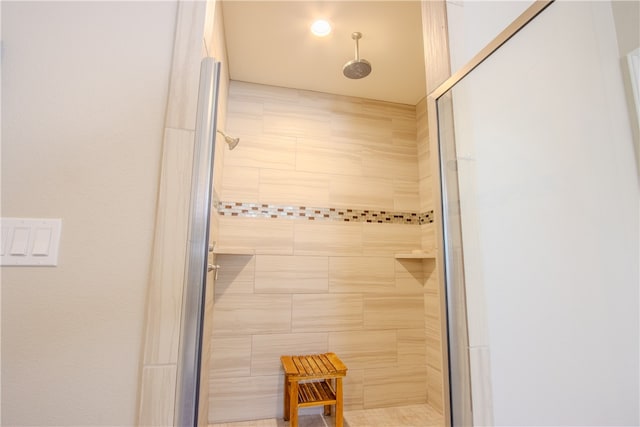 bathroom featuring a shower with door