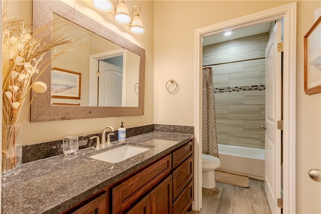 full bathroom featuring toilet, shower / tub combo, vanity, and wood-type flooring