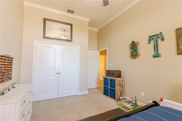 carpeted bedroom with ornamental molding, a towering ceiling, ceiling fan, and a closet