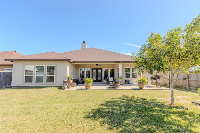 back of house featuring a patio area, a lawn, and ceiling fan