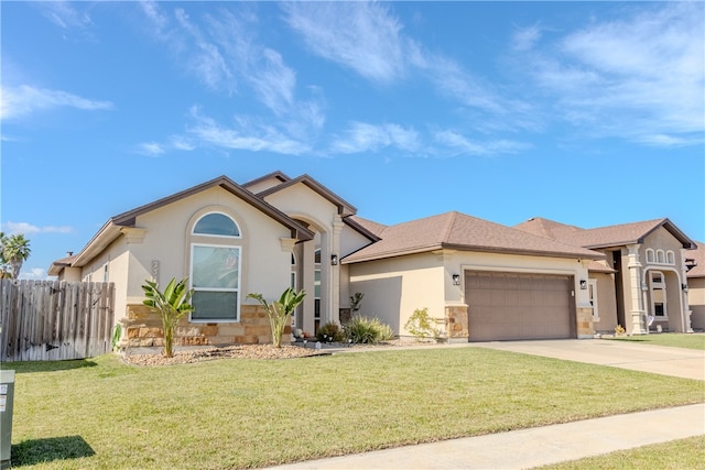 view of front of home with a garage and a front lawn