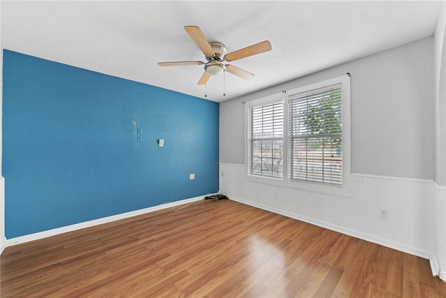 spare room with ceiling fan and wood-type flooring