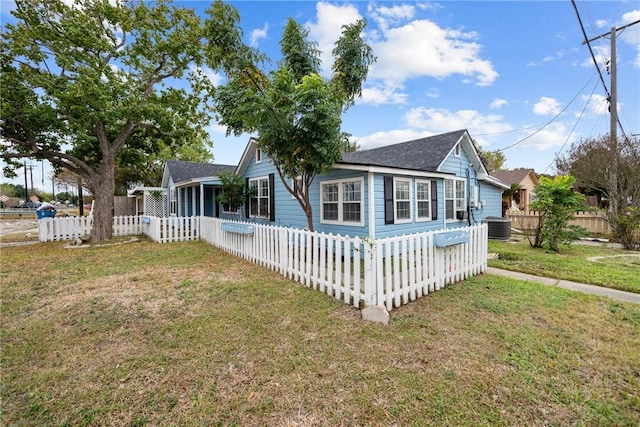 view of front of house featuring central AC unit and a front yard