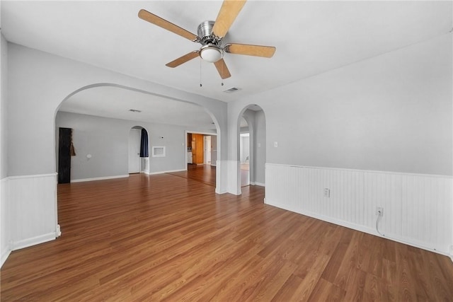 unfurnished living room featuring hardwood / wood-style flooring and ceiling fan